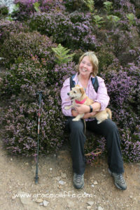 Grace Jolliffe holding small dog - illustrating an article about walking the Sugarloaf